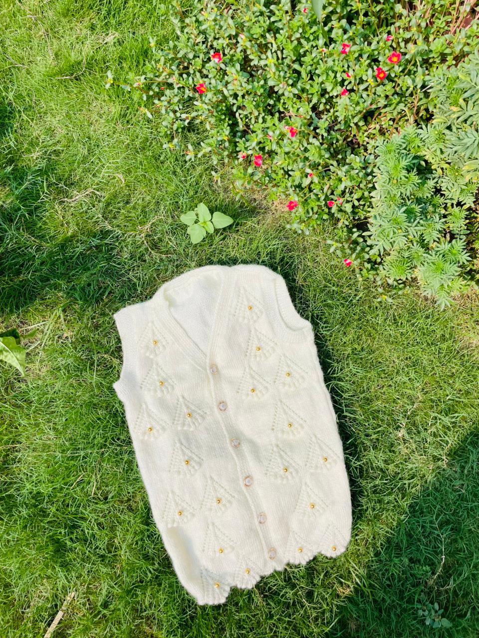 Hand-Knitted White Woolen Baby Vest with Pearl Detailing